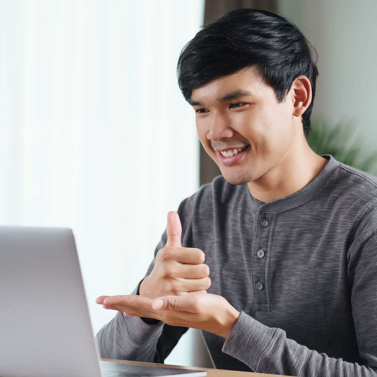 Man in meeting using sign language