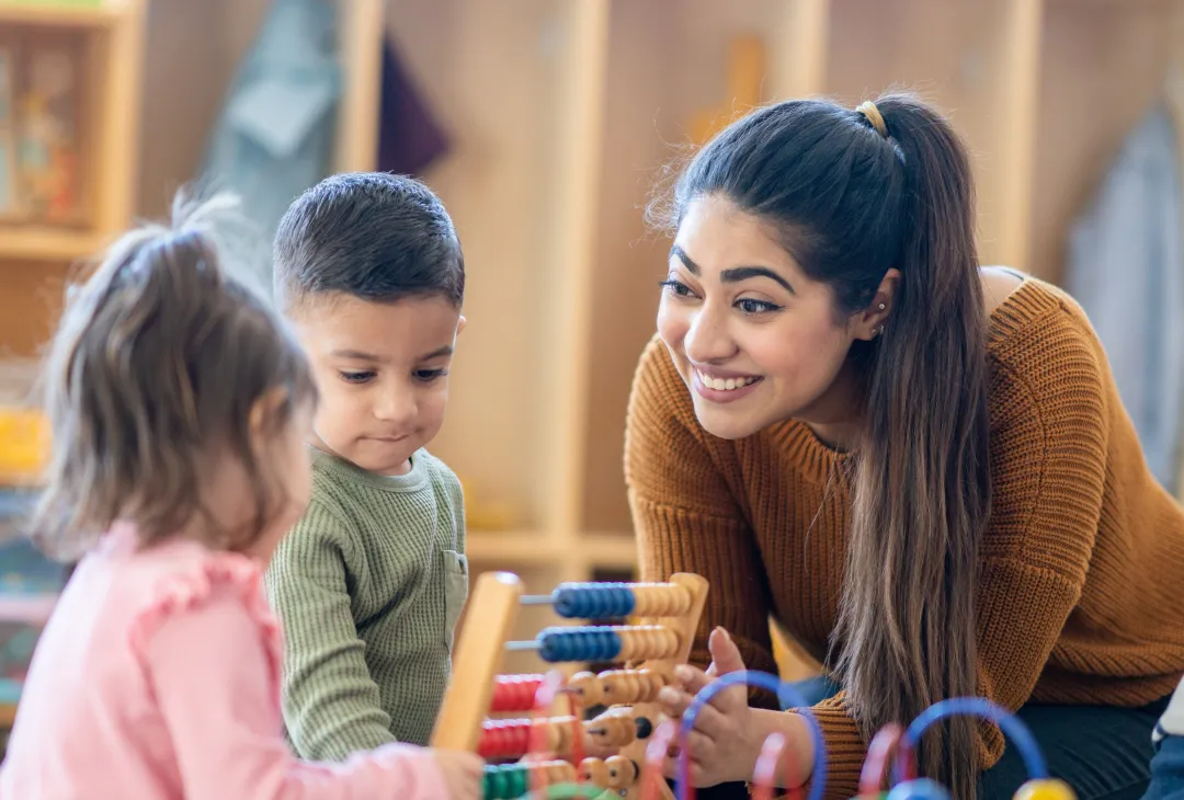 Childcare worker playing with children
