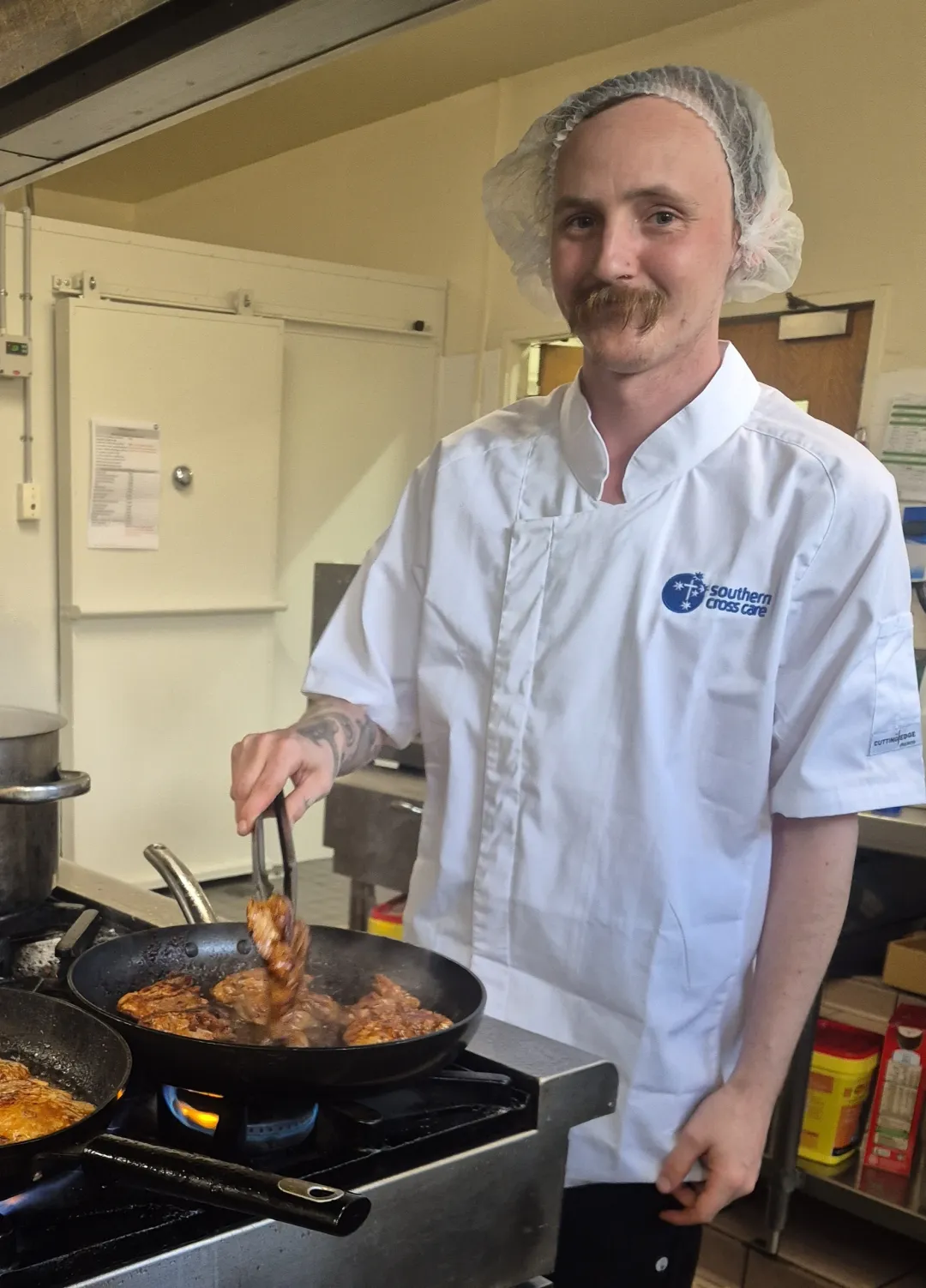 Chef in a kitchen cooking on a stovetop