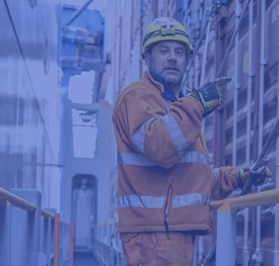 Older man working outdoors in an industrial setting