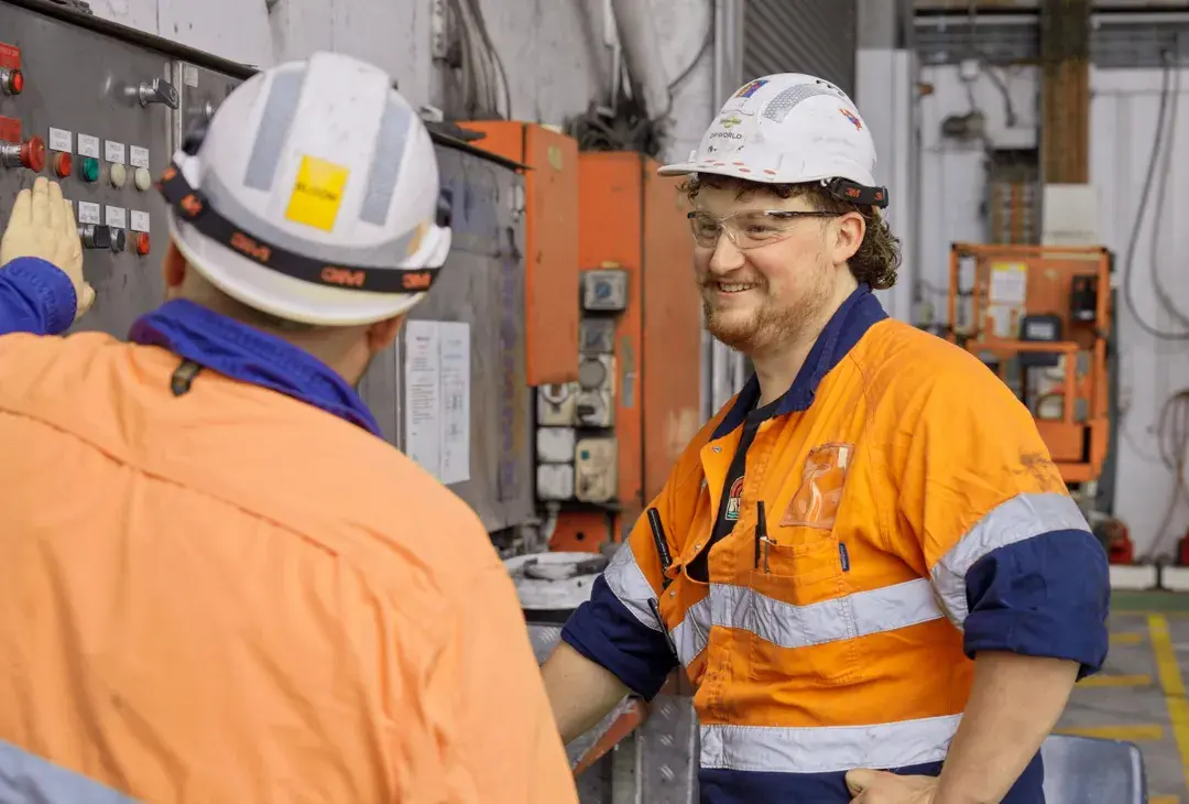 Male electrician talking with a coworker at a work site