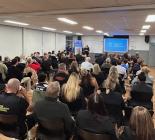 Group of people in a room watching a presentation