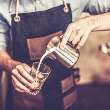 Hospitality apprentice preparing a coffee