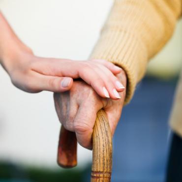 A hand helping an old person