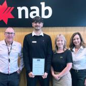 Four people standing in front of NAB