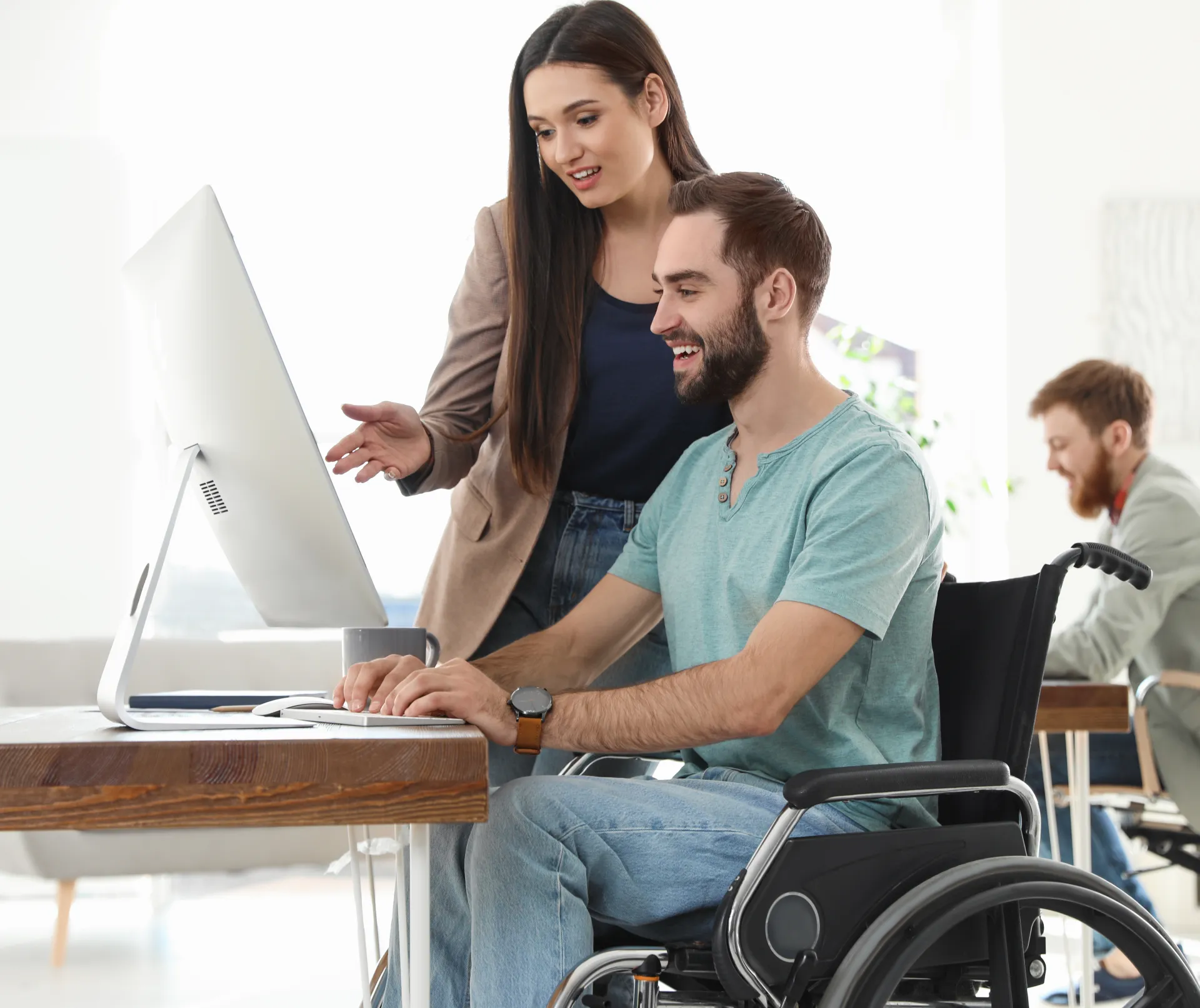 disability smiling Employment Services Bridging Inclusion Through Employment office young woman and man looking at computer screen in discussion chair clothing computer furniture indoor laptop person sitting wall wheelchair