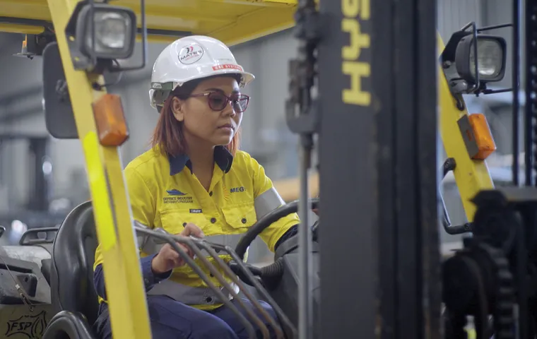 A worker driving a forklift in a warehouse.