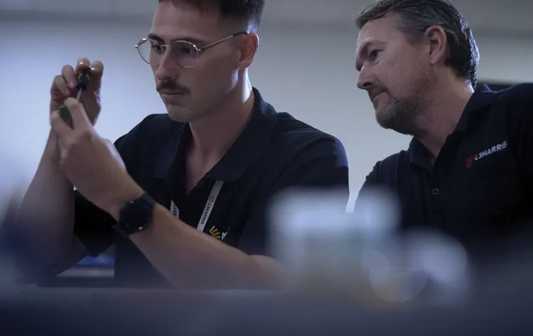 Two workers inspecting a gadget
