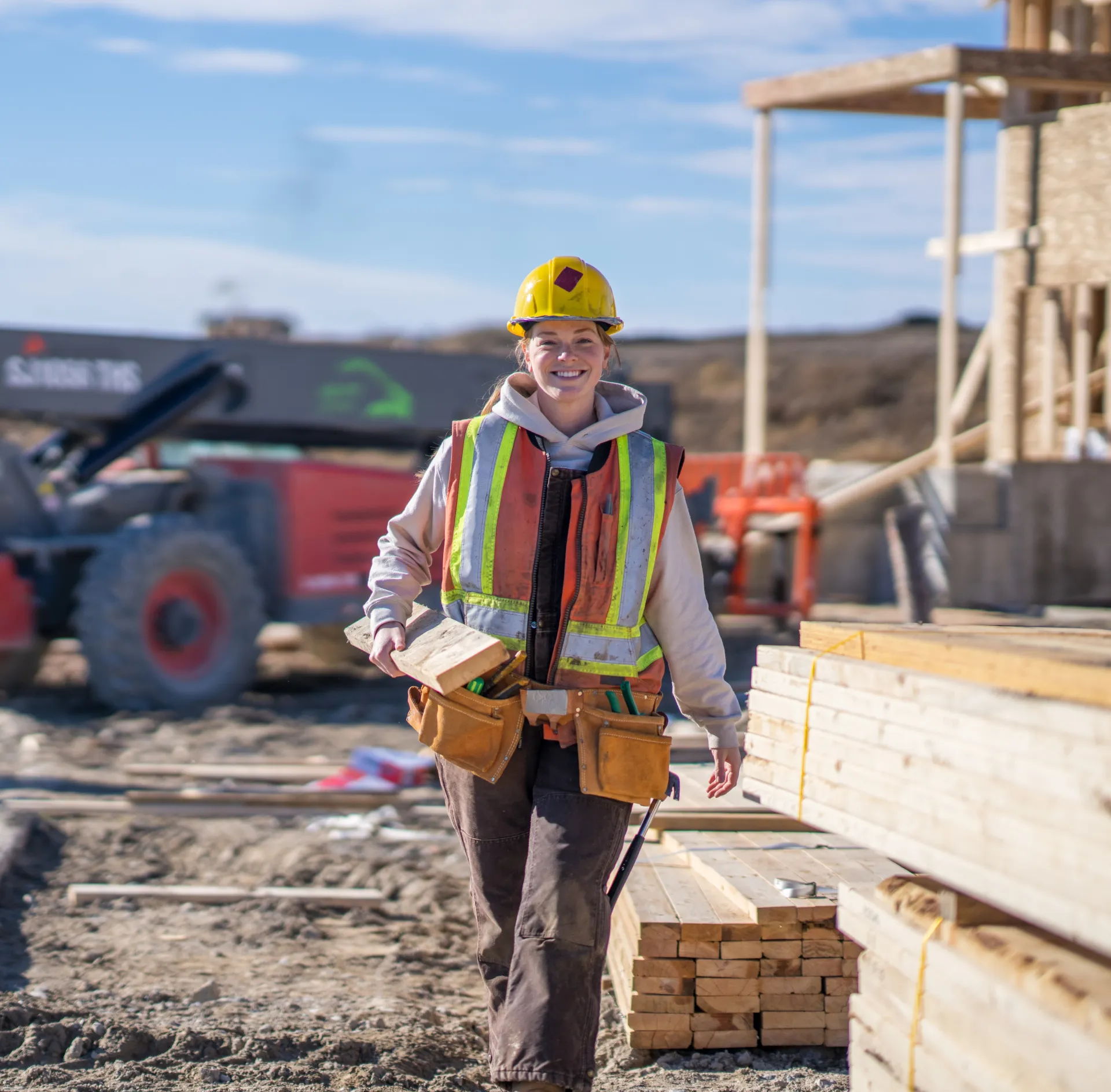 Construction worker walking through an outdoor work site.