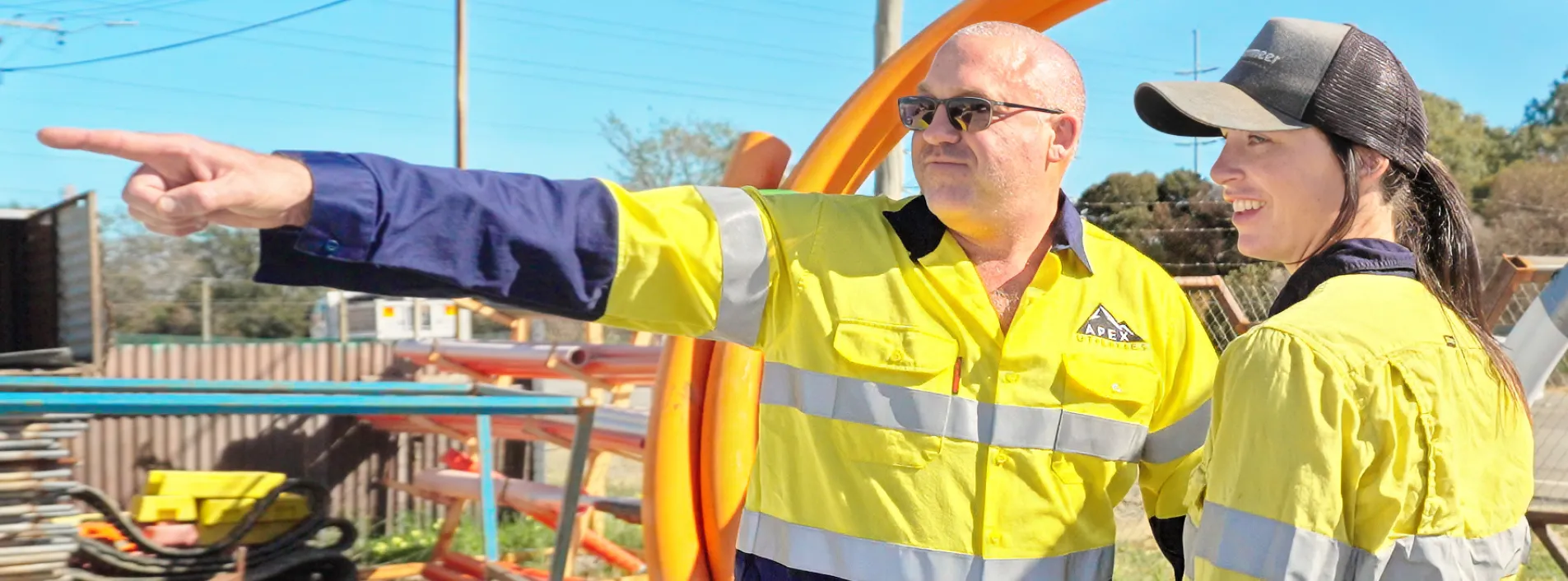 Two workers at an outdoor worksite