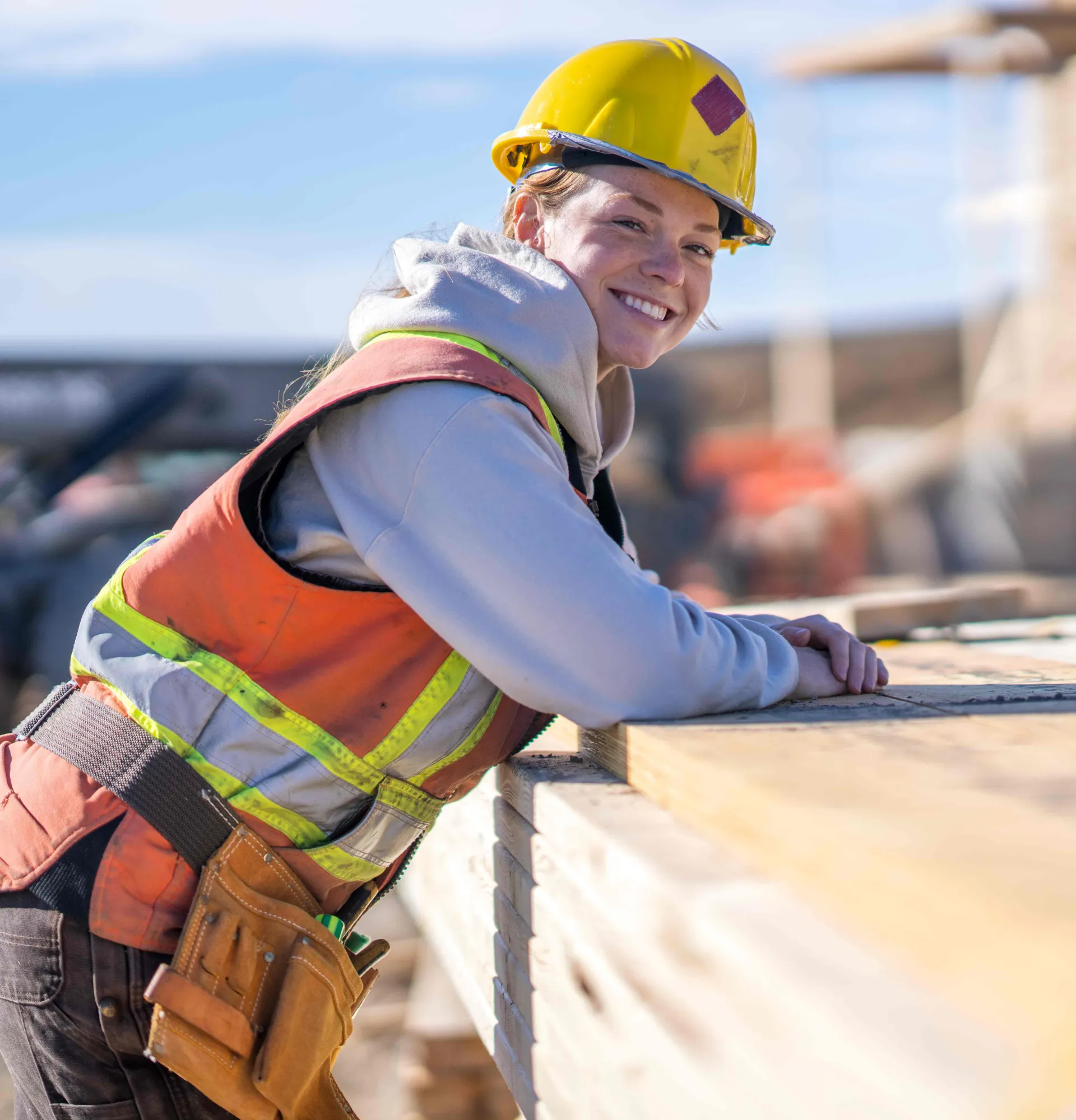 Female construction worker smiling while onsite