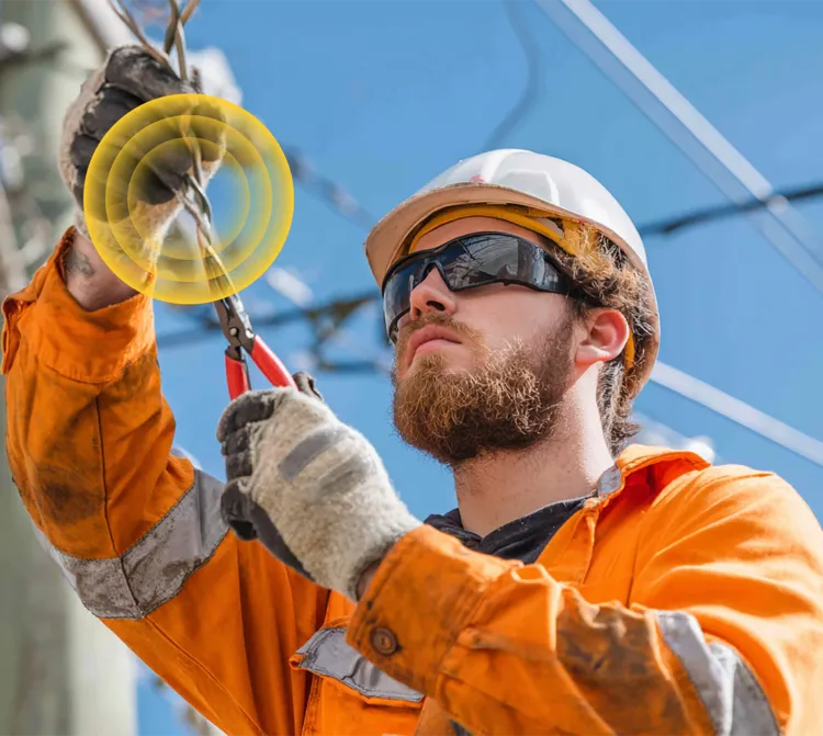 Electrician outside wearing sunglasses using plyers on wires