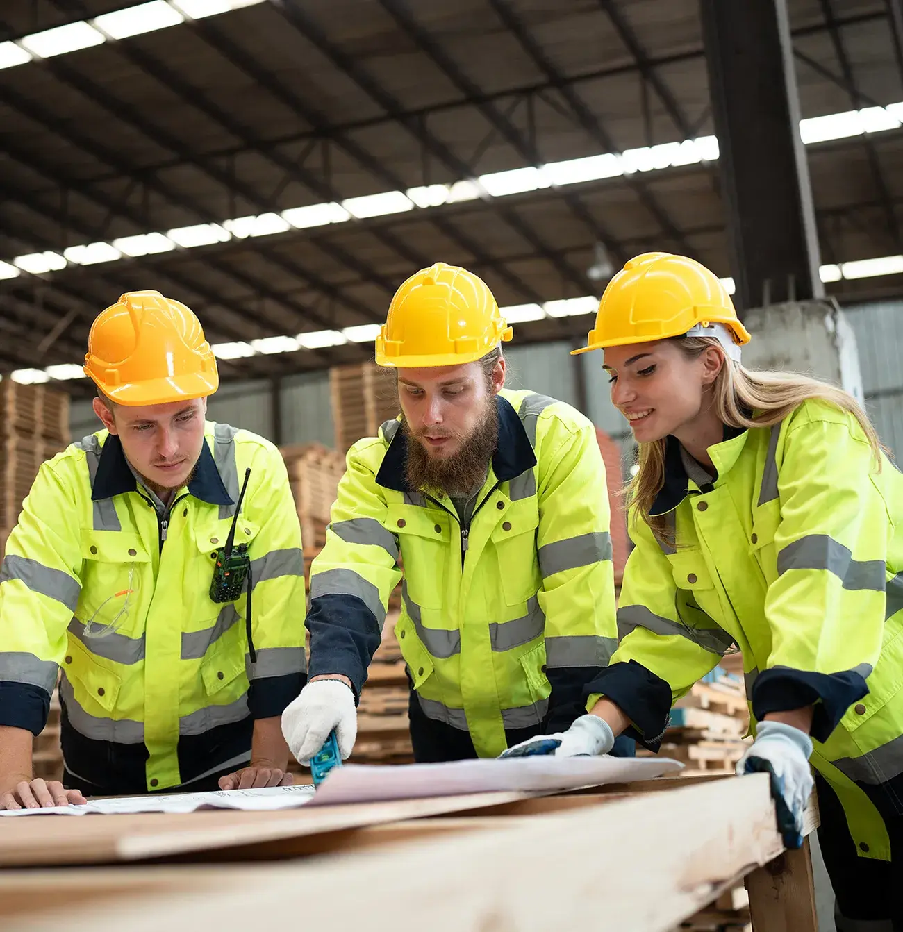 Blue collar workers standing at a work bench