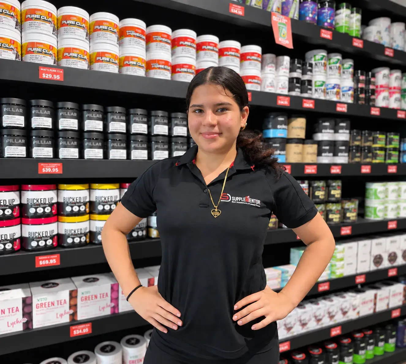 Young person proudly standing in a supplement store.