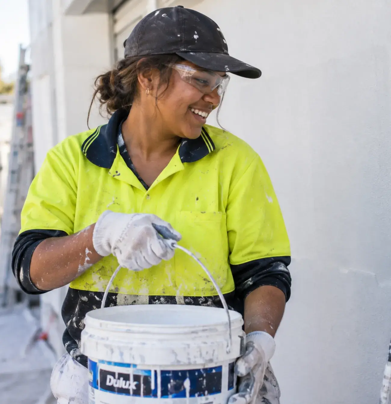 First Nations woman painting and smiling