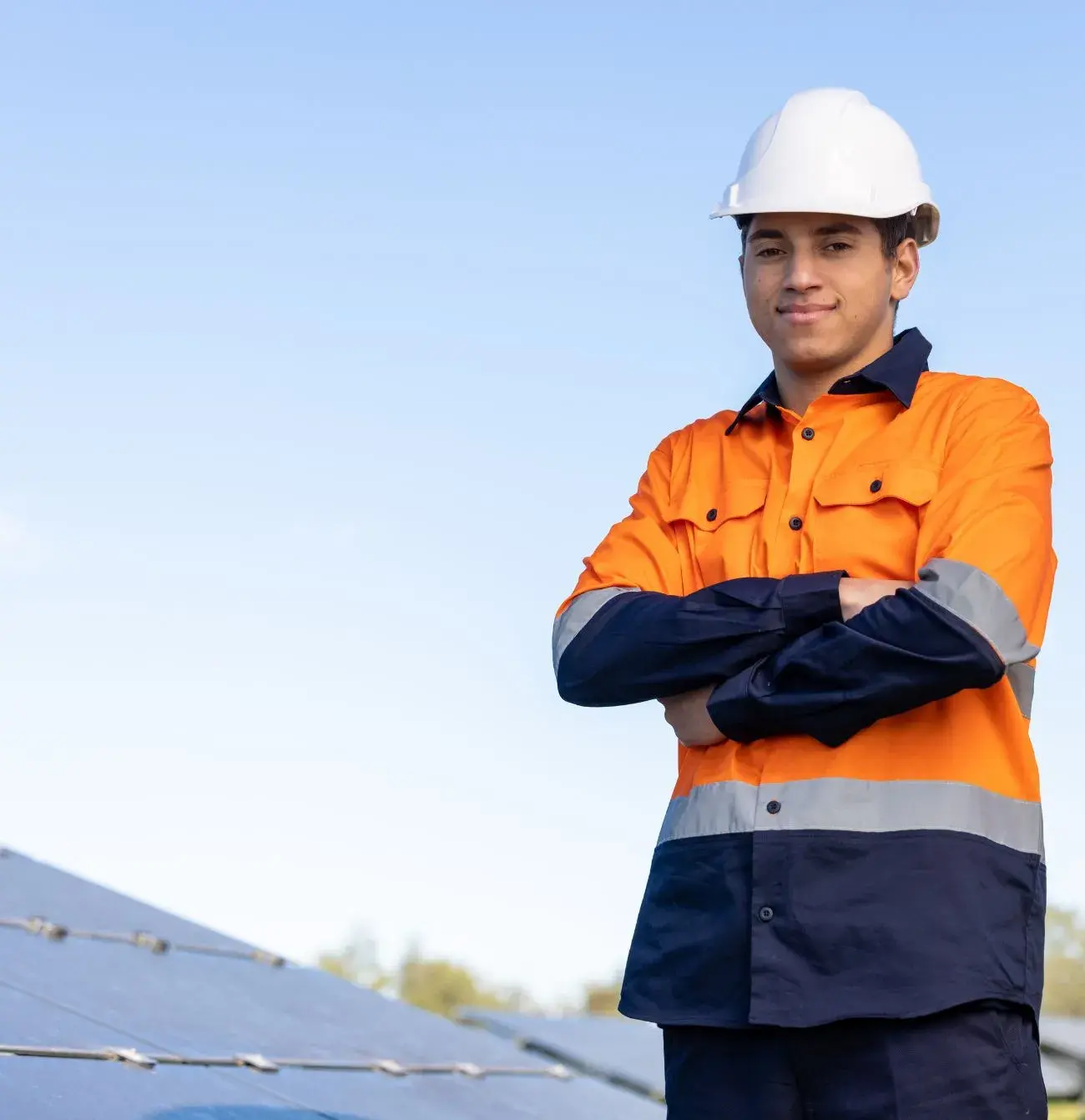 Construction worker with arms folded standing outdoors